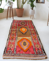 Vintage Turkish runner rug in a living room setting, pile rug, Turkish rug, vintage rug, portland, rug shop, bright colors, wild shaman, soft rug, bold color, Portland, Oregon, rug store, rug shop, local shop, antique rug