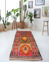 Vintage Turkish runner rug in a living room setting, pile rug, Turkish rug, vintage rug, portland, rug shop, bright colors, wild shaman, soft rug, bold color, Portland, Oregon, rug store, rug shop, local shop, antique rug