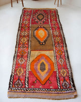 Vintage Turkish runner rug in a living room setting, pile rug, Turkish rug, vintage rug, portland, rug shop, bright colors, wild shaman, soft rug, bold color, Portland, Oregon, rug store, rug shop, local shop, antique rug