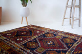 Vintage Turkish runner rug in a living room setting, pile rug, Turkish rug, vintage rug, portland, rug shop, bright colors, wild shaman, soft rug, bold color, Portland, Oregon, rug store, rug shop, local shop, antique rug