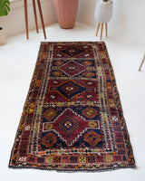 Vintage Turkish runner rug in a living room setting, pile rug, Turkish rug, vintage rug, portland, rug shop, bright colors, wild shaman, soft rug, bold color, Portland, Oregon, rug store, rug shop, local shop, antique rug