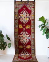 Vintage Turkish runner rug in a living room setting, pile rug, Turkish rug, vintage rug, portland, rug shop, bright colors, wild shaman, soft rug, bold color, Portland, Oregon, rug store, rug shop, local shop, antique rug