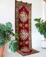 Vintage Turkish runner rug in a living room setting, pile rug, Turkish rug, vintage rug, portland, rug shop, bright colors, wild shaman, soft rug, bold color, Portland, Oregon, rug store, rug shop, local shop, antique rug
