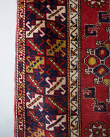 Vintage Turkish rug in a living room setting, pile rug, Turkish rug, vintage rug, portland, rug shop, bright colors, wild shaman, soft rug, bold color, Portland, Oregon, rug store, rug shop, local shop, antique rug