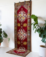 Vintage Turkish runner rug in a living room setting, pile rug, Turkish rug, vintage rug, portland, rug shop, bright colors, wild shaman, soft rug, bold color, Portland, Oregon, rug store, rug shop, local shop, antique rug