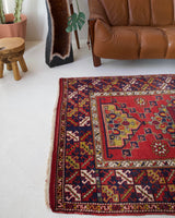 Vintage Turkish rug in a living room setting, pile rug, Turkish rug, vintage rug, portland, rug shop, bright colors, wild shaman, soft rug, bold color, Portland, Oregon, rug store, rug shop, local shop, antique rug