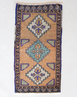 Vintage Turkish mini rug in room decor setting, old rug, antique rug, pastel colors, faded colors, Turkish rug, vintage rug, soft rug, Portland, Oregon, rug store, rug shop, local shop