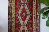 Vintage Turkish runner rug in a living room setting, pile rug, Turkish rug, vintage rug, portland, rug shop, bright colors, wild shaman, soft rug, bold color, Portland, Oregon, rug store, rug shop, local shop, antique rug