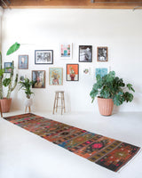 Vintage Turkish runner rug in a living room setting, pile rug, Turkish rug, vintage rug, portland, rug shop, bright colors, wild shaman, soft rug, bold color, Portland, Oregon, rug store, rug shop, local shop, antique rug