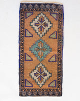 Vintage Turkish mini rug in room decor setting, old rug, antique rug, pastel colors, faded colors, Turkish rug, vintage rug, soft rug, Portland, Oregon, rug store, rug shop, local shop