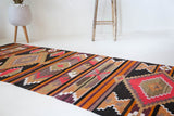 Vintage Turkish runner rug in a living room setting, pile rug, Turkish rug, vintage rug, portland, rug shop, bright colors, wild shaman, soft rug, bold color, Portland, Oregon, rug store, rug shop, local shop, antique rug
