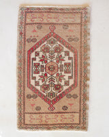 Vintage Turkish mini rug in room decor setting, old rug, antique rug, pastel colors, faded colors, Turkish rug, vintage rug, soft rug, Portland, Oregon, rug store, rug shop, local shop