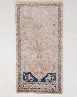 Vintage Turkish mini rug in room decor setting, old rug, antique rug, pastel colors, faded colors, Turkish rug, vintage rug, soft rug, Portland, Oregon, rug store, rug shop, local shop