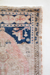 Vintage Turkish mini rug in room decor setting, old rug, antique rug, pastel colors, faded colors, Turkish rug, vintage rug, soft rug, Portland, Oregon, rug store, rug shop, local shop