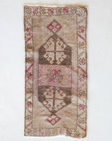 Vintage Turkish mini rug in room decor setting, old rug, antique rug, pastel colors, faded colors, Turkish rug, vintage rug, soft rug, Portland, Oregon, rug store, rug shop, local shop