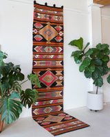 Vintage Turkish runner rug in a living room setting, pile rug, Turkish rug, vintage rug, portland, rug shop, bright colors, wild shaman, soft rug, bold color, Portland, Oregon, rug store, rug shop, local shop, antique rug