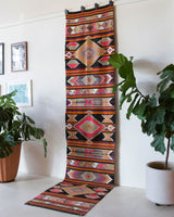 Vintage Turkish runner rug in a living room setting, pile rug, Turkish rug, vintage rug, portland, rug shop, bright colors, wild shaman, soft rug, bold color, Portland, Oregon, rug store, rug shop, local shop, antique rug