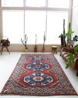 Vintage Turkish rug in a living room setting, pile rug, Turkish rug, vintage rug, portland, rug shop, bright colors, wild shaman, soft rug, bold color, Portland, Oregon, rug store, rug shop, local shop, antique rug