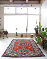 Vintage Turkish rug in a living room setting, pile rug, Turkish rug, vintage rug, portland, rug shop, bright colors, wild shaman, soft rug, bold color, Portland, Oregon, rug store, rug shop, local shop, antique rug