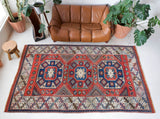 Vintage Turkish rug in living room setting, old rug, antique rug, pastel colors, faded colors, Turkish rug, vintage rug, soft rug, Portland, Oregon, rug store, rug shop, local shop