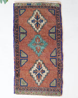 Vintage Turkish mini rug in room decor setting, old rug, antique rug, pastel colors, faded colors, Turkish rug, vintage rug, soft rug, Portland, Oregon, rug store, rug shop, local shop