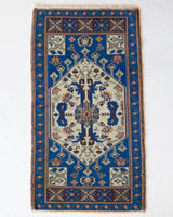 Vintage Turkish mini rug in room decor setting, old rug, antique rug, pastel colors, faded colors, Turkish rug, vintage rug, soft rug, Portland, Oregon, rug store, rug shop, local shop