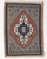 Vintage Turkish mini rug in room decor setting, old rug, antique rug, pastel colors, faded colors, Turkish rug, vintage rug, soft rug, Portland, Oregon, rug store, rug shop, local shop