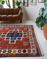 Vintage Turkish rug in a living room setting, pile rug, Turkish rug, vintage rug, portland, rug shop, bright colors, wild shaman, soft rug, bold color, Portland, Oregon, rug store, rug shop, local shop