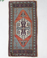 Vintage Turkish mini rug in room decor setting, old rug, antique rug, pastel colors, faded colors, Turkish rug, vintage rug, soft rug, Portland, Oregon, rug store, rug shop, local shop