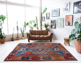 Vintage Turkish rug in a living room setting, pile rug, Turkish rug, vintage rug, portland, rug shop, bright colors, wild shaman, soft rug, bold color, Portland, Oregon, rug store, rug shop, local shop