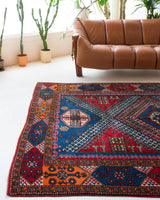 Vintage Turkish rug in a living room setting, pile rug, Turkish rug, vintage rug, portland, rug shop, bright colors, wild shaman, soft rug, bold color, Portland, Oregon, rug store, rug shop, local shop