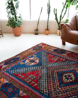 Vintage Turkish rug in a living room setting, pile rug, Turkish rug, vintage rug, portland, rug shop, bright colors, wild shaman, soft rug, bold color, Portland, Oregon, rug store, rug shop, local shop