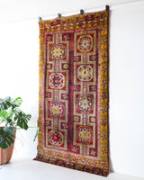 Vintage Turkish rug in a living room setting, pile rug, Turkish rug, vintage rug, portland, rug shop, bright colors, wild shaman, soft rug, bold color, Portland, Oregon, rug store, rug shop, local shop, antique rug, distressed rug, worn out rug