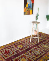 Vintage Turkish rug in a living room setting, pile rug, Turkish rug, vintage rug, portland, rug shop, bright colors, wild shaman, soft rug, bold color, Portland, Oregon, rug store, rug shop, local shop, antique rug, distressed rug, worn out rug