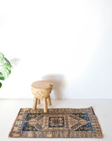 Vintage Turkish mini rug in room decor setting, old rug, antique rug, pastel colors, faded colors, Turkish rug, vintage rug, soft rug, Portland, Oregon, rug store, rug shop, local shop