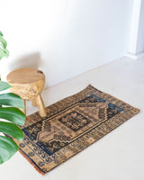 Vintage Turkish mini rug in room decor setting, old rug, antique rug, pastel colors, faded colors, Turkish rug, vintage rug, soft rug, Portland, Oregon, rug store, rug shop, local shop