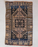 Vintage Turkish mini rug in room decor setting, old rug, antique rug, pastel colors, faded colors, Turkish rug, vintage rug, soft rug, Portland, Oregon, rug store, rug shop, local shop