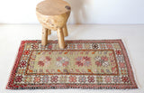 Vintage Turkish mini rug in room decor setting, old rug, antique rug, pastel colors, faded colors, Turkish rug, vintage rug, soft rug, Portland, Oregon, rug store, rug shop, local shop