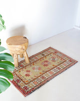 Vintage Turkish mini rug in room decor setting, old rug, antique rug, pastel colors, faded colors, Turkish rug, vintage rug, soft rug, Portland, Oregon, rug store, rug shop, local shop