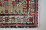 Vintage Turkish mini rug in room decor setting, old rug, antique rug, pastel colors, faded colors, Turkish rug, vintage rug, soft rug, Portland, Oregon, rug store, rug shop, local shop
