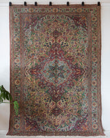 Vintage Turkish rug in living room setting, old rug, antique rug, pastel colors, faded colors, Turkish rug, vintage rug, soft rug, Portland, Oregon, rug store, rug shop, local shop