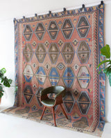 Vintage kilim rug in living room setting, old rug, antique rug, pastel colors, faded colors, Turkish rug, vintage rug, soft rug, Portland, Oregon, rug store, rug shop, local shop