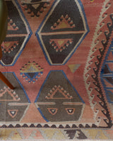 Vintage kilim rug in living room setting, old rug, antique rug, pastel colors, faded colors, Turkish rug, vintage rug, soft rug, Portland, Oregon, rug store, rug shop, local shop