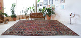 Antique Persian area rug in a living room setting, pile rug, vintage rug, portland, rug shop, bright colors, wild shaman, soft rug, bold color, Portland, Oregon, rug store, rug shop, local shop, antique rug, Persian rug, handmade rug, wool rug