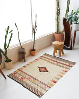 Vintage kilim rug in room decor setting, old rug, antique rug, pastel colors, faded colors, Turkish rug, vintage rug, soft rug, Portland, Oregon, rug store, rug shop, local shop, antique rug