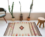 Vintage kilim rug in room decor setting, old rug, antique rug, pastel colors, faded colors, Turkish rug, vintage rug, soft rug, Portland, Oregon, rug store, rug shop, local shop, antique rug