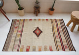Vintage kilim rug in room decor setting, old rug, antique rug, pastel colors, faded colors, Turkish rug, vintage rug, soft rug, Portland, Oregon, rug store, rug shop, local shop, antique rug
