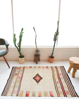 Vintage kilim rug in room decor setting, old rug, antique rug, pastel colors, faded colors, Turkish rug, vintage rug, soft rug, Portland, Oregon, rug store, rug shop, local shop, antique rug