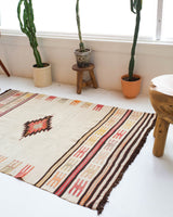 Vintage kilim rug in room decor setting, old rug, antique rug, pastel colors, faded colors, Turkish rug, vintage rug, soft rug, Portland, Oregon, rug store, rug shop, local shop, antique rug