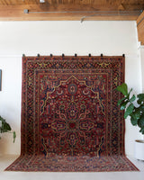 Antique Persian area rug in a living room setting, pile rug, vintage rug, portland, rug shop, bright colors, wild shaman, soft rug, bold color, Portland, Oregon, rug store, rug shop, local shop, antique rug, Persian rug, handmade rug, wool rug